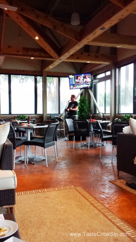 Enjoying live music in the enclosed patio. Roof+AC means summertime heat and storms in Florida cannot interfere with a fun Happy Hour ambiance!