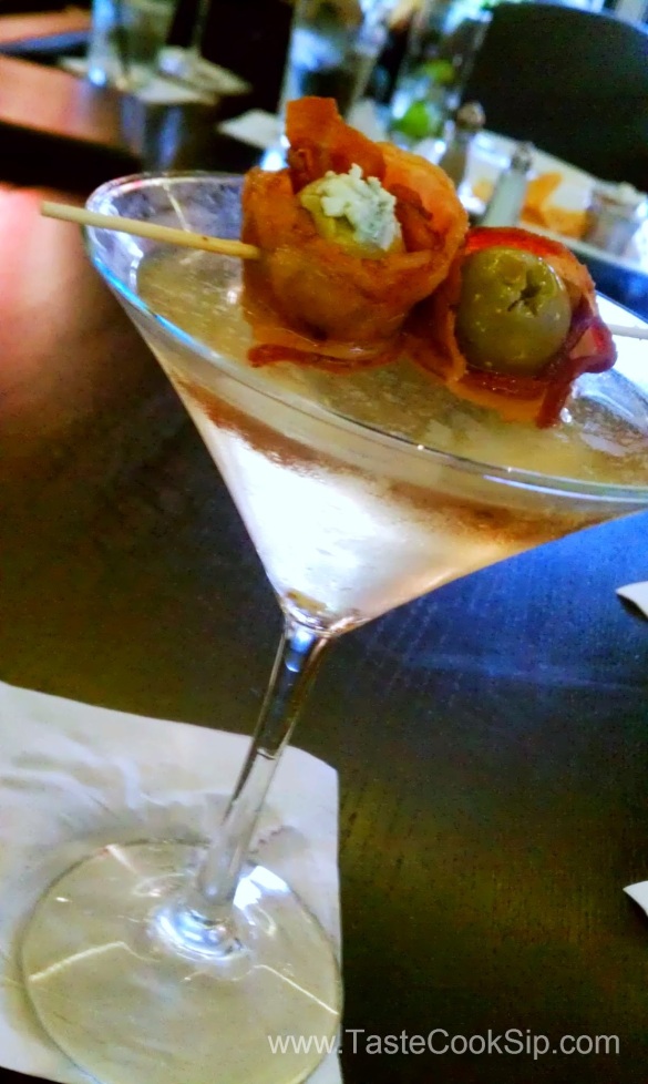 When Pigs Fly. A dirty martini topped with BACON wrapped, blue cheese stuffed olives. Oh my!